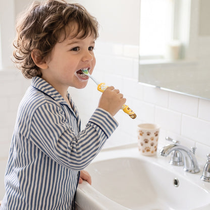 Colourful kids toothbrush with soft bristles and toy figure
