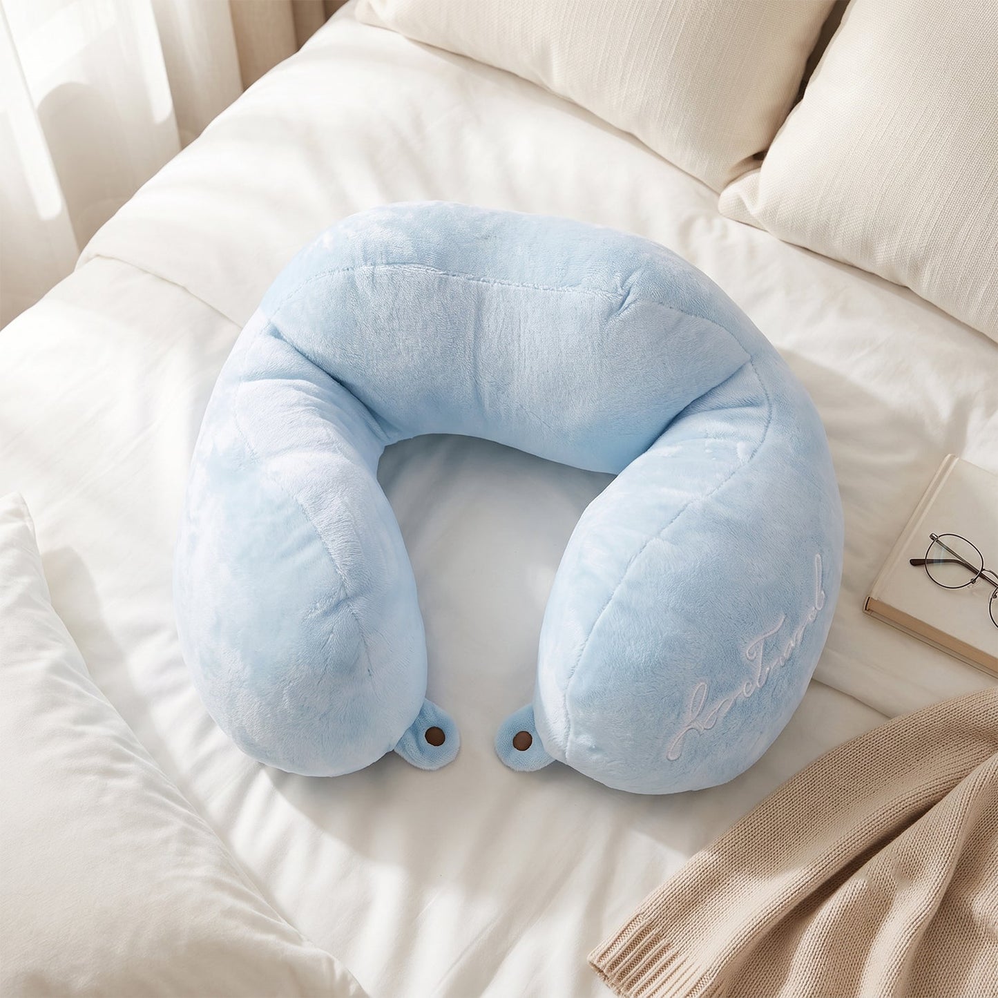 Blue plush neck cushion for flights, cars and trains