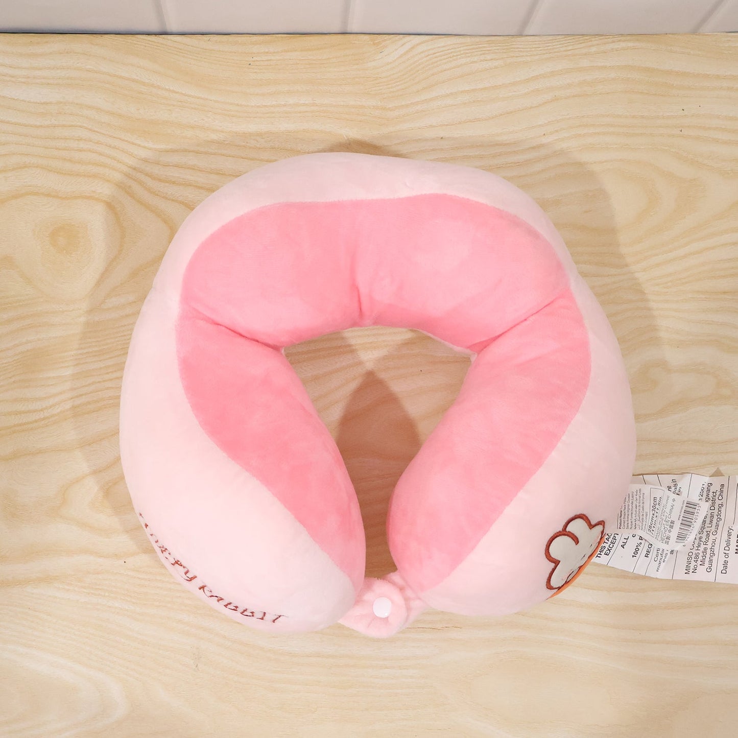 Lightweight pink and white U shape pillow for restful travel